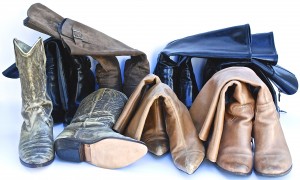 Several pairs of boots collapsed and stored on their sides, illustrating improper boot storage and organization.