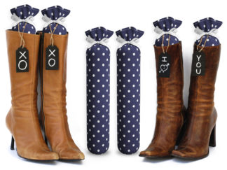 One Pair of 15-inch-tall fabric boot inserts covered in blue fabric with white polka dots and with black wooden tags reading "I Love You.” tied around the top of the insert. Any message can be written on the black wooden tags. And two pairs of boots with the boot tree inserts inside them keeping them upright.