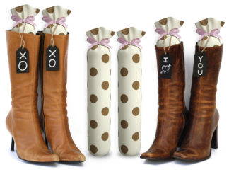 One Pair of 15-inch-tall fabric boot inserts covered in cream fabric with brown polka dots and with black wooden tags reading "I Love You.” tied around the top of the insert. Any message can be written on the black wooden tags. And two pairs of boots with the boot tree inserts inside them keeping them upright.