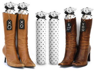 One Pair of 15-inch-tall fabric boot inserts covered in white fabric with black polka dots and with black wooden tags reading "I Love You.” tied around the top of the insert. Any message can be written on the black wooden tags. And two pairs of boots with the boot tree inserts inside them keeping them upright.