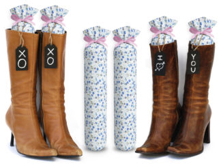 One Pair of 15-inch-tall fabric boot inserts covered in blue floral fabric and with black wooden tags reading "I Love You.” tied around the top of the insert. Any message can be written on the black wooden tags. And two pairs of boots with the boot tree inserts inside them keeping them upright.