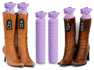 One Pair of 15-inch-tall fabric boot inserts covered in purple and white plaid fabric and with black wooden tags reading "I Love You.” tied around the top of the insert. Any message can be written on the black wooden tags. And two pairs of boots with the boot tree inserts inside them keeping them upright.