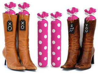 One Pair of 15-inch-tall fabric boot inserts covered in pink fabric with white polka dots and with black wooden tags reading "I Love You.” tied around the top of the insert. Any message can be written on the black wooden tags. And two pairs of boots with the boot tree inserts inside them keeping them upright.